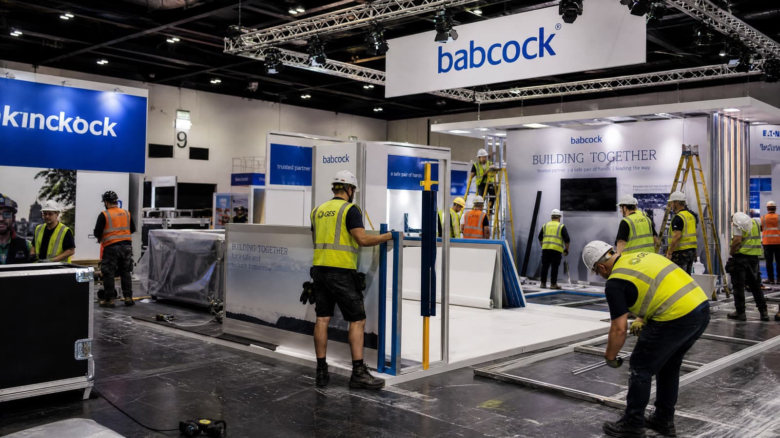 Qualified installation and dismantle team actively building a trade show booth on the exhibition floor