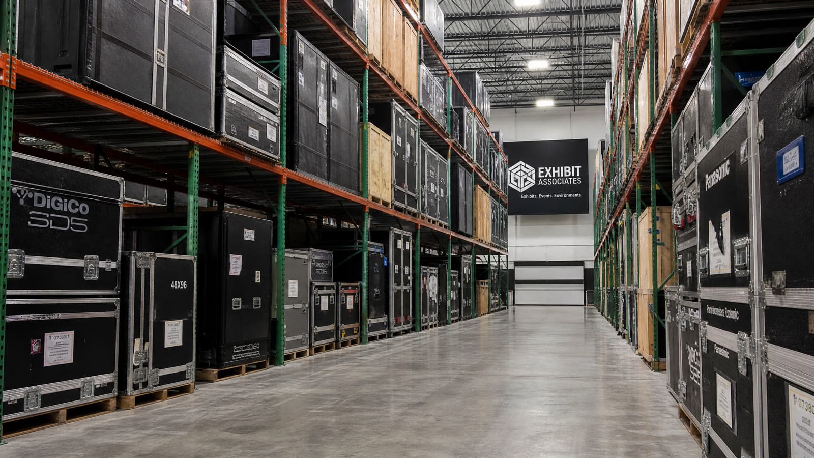 Organized exhibit warehousing facility with secure crates and road cases ready for deployment